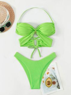 Stand out with this stylish two-piece bikini from Rita Rosa Brazilian Beachwear in vibrant green neon. The top features a center gold ring, bandage cut-out design, and crisscross back tie straps for a secure fit. Removable pads offer extra support. The thong-style bottom with a high-waisted fit accentuates your curves. Perfect for any fashion-forward beachgoer. Imported worldwide 🌍 Criss Cross Ring, Neon Printing, Halter Swimsuit, Beachwear Collection, Halter Bra, Green Neon, Swimwear Sets, Swimsuits Halter, Cut Out Design