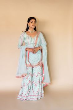 Geher - Powder Blue Georgette Kurta Sharara w/ Mirror & Linear Embroidery Let your graceful be humbled with this sophisticated Sharara set that comes with intricate embroidery! Product Specifications: Color Powder Blue & Pink Fabric Georgette & Net Work Mirror, Sequin, Bead Handwork Occasion Reception, Engagement, Bridal Style Indo-western Sharara set Care Dry Clean Purchase Includes Kurta, Sharara & Dupatta Kurta: Fabric - Powder Blue Georgette Work - Mirror & Sequins work Neckline - V-neckline Elegant Semi-stitched Sharara With Multicolor Embroidery, Anarkali Palazzo Set With Intricate Multicolor Embroidery, Eid Wedding Palazzo Set With Multicolor Embroidery, Wedding Palazzo Set With Multicolor Embroidery For Eid, Light Blue Zari Work Anarkali Set For Reception, Light Blue Anarkali Set With Intricate Embroidery, Semi-stitched Chikankari Embroidery Sets For Reception, Light Blue Resham Embroidery Sharara For Eid, Traditional Light Blue Festive Palazzo Set