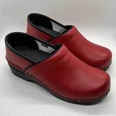 Comfy Nib Bjork Swedish Comfort Ella Red/Black Leather Clogs Shoes. Size 39-40 = Us Size 8-9.5. The Ella From Bjork Swedish Comfort Is A Classic Yet Functional Clog, Hand-Made In Europe. Genuine Leather Upper. Provides All Day Comfort, Thanks To It's Rocker Bottom, Softer Insole And Arch Support Design. Hand-Made In Europe Genuine Leather Pu Outsole With Rocker Bottom To Propel The Foot Forward While Providing A High Degree Of Shock Absorption And Arch Support Anti-Bacterial Midsole Cushioned Le Comfortable Red Clogs With Round Toe, Red Slip-on Comfortable Clogs, Comfortable Red Slip-on Clogs, Red Synthetic Clogs With Cushioned Footbed, Red Closed Toe Synthetic Clogs, Casual Clogs With Red Sole And Round Toe, Leather Clogs With Slip-resistant Round Toe, Red Closed Toe Clogs With Cushioned Footbed, Red Synthetic Clogs With Rubber Sole