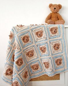 a crocheted teddy bear baby blanket on a chair next to a stuffed animal