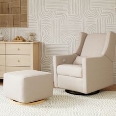 a chair and ottoman in a room with a wallpapered pattern on the wall