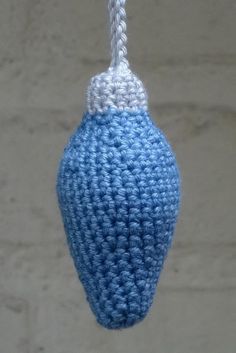 a blue and white crochet hanging ornament