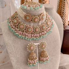 Statement bridal set made with antique plating, champagne crystals, Mint and pink gems. Finished with an abundance on tiny bead detailing in pearl, mint and ombre pink glass drops.  Set comes complete as seen with choker (1 inch wide), necklace(1.5 inch wide, Jhumka earrings (3 inch length) and statement Tikka (2.5 inch length x 2 inch width) Ready to ship with Gift Box. Bridal Survival Kit, Pakistani Bridal Jewelry, Indian Wedding Jewelry Sets, Perhiasan India, Indian Bridal Jewelry Sets, Pink And Mint, Bridal Jewellery Design, Double Necklace, Ombre Pink