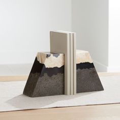 two bookends sitting on top of a carpeted floor next to each other