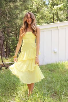 Bright yellow maxi dress with ruffle tier bottom and adjustable strap details Yellow Summer Dress With Ruffled Straps, Yellow Summer Dresses With Ruffled Straps, Yellow Dresses With Ruffled Straps For Summer, Ruffled Tiered Maxi Dress For Brunch, Ruffled Tiered Skirt Maxi Dress For Brunch, Yellow Ruffle Dress For Spring, Spring Yellow Ruffled Dresses, Yellow Ruffled Dress For Spring, Brunch Tiered Midi Dress With Ruffled Skirt