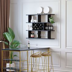 a bar with two stools next to it and bottles on the wall behind it