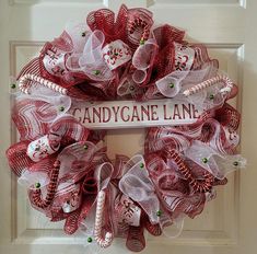 a red and white wreath with candy canes on it