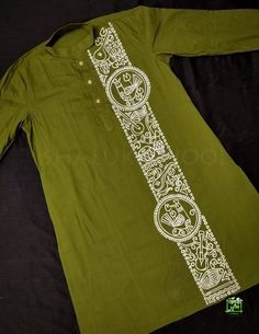 a green shirt with white designs on it