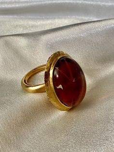 Beautiful KJL vintage ring featuring gold tone metal and beautiful large oval amber.  Ring size 6. Gold Ring With Large Oval Cabochon Stone, Gold Oval Dome Ring With Gemstone, Vintage Gold Dome Ring With Oval Cabochon, Gold Oval Ring With Large Stone, Gold Oval Dome Ring With Cabochon, Gold Oval Ruby Ring For Formal Occasions, Vintage Oval Gemstone Dome Ring, Formal Amber Oval Cabochon Rings, Gold Cabochon Oval Rings