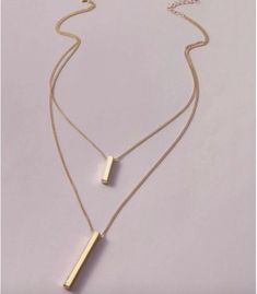 Double Layered Gold Bar Pendant Chain Necklace This is a simple yet elegant and dainty double layered gold bar chain pendant necklace this is the perfect necklace for that elegant, layered look. This necklace will complement any out perfectly or make for the perfect gift for any occasion. Gold Bar Pendant, Bar Pendant, Gold Bar, Chain Pendant, Layered Look, Chain Pendants, Arrow Necklace, Chain Necklace, Gold Necklace