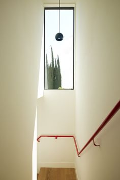 an empty stairwell leading up to a window