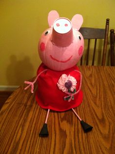 a peppa pig sitting on top of a wooden table