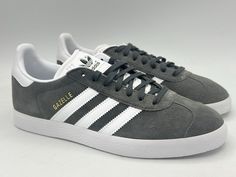 Step out in style with these adidas Originals Gazelle sneakers in a sleek grey, gray, and white colorway. These lace-up sneakers feature a low-top shoe shaft style and a standard shoe width, making them comfortable for gym and training activities, walking, and even the beach. The suede upper material adds a touch of sophistication to the design, while the solid pattern and adidas Gazelle product line give them a timeless and classic look. With a UK shoe size of 8 and a US shoe size of 8.5, these sneakers are perfect for any casual or activewear occasion. They are not signed, customized, or manufactured in any other country/region other than Vietnam. Get your hands on these stylish sneakers today and elevate your sneaker game! Gray Adidas Sneakers For Jogging, Gray Lace-up Adidas Sneakers, Luxury Gray Adidas Sneakers, Gray Adidas Sports Sneakers, Gray Athletic Fit Sneakers, Durable, Adidas Gazelle Grey, Adidas Athletic Shoes, Train Activities, Sneaker Games