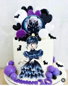 a cake decorated with an image of a woman in a blue dress and purple balloons