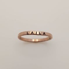 Mother's Day Gift | Personalized stackable ring, engraved with a name, date, or special word. This listing is for a 14k rose gold filled ring, but we do have listings for fine silver and gold filled as well. Metal: 14k rose gold filled  Dimensions: 2mm tall on average, but our rings are handmade so variations will occur. Font: uppercase thick block Unsure what size you need? We highly recommend using our ring sizer for an accurate fit. Some people find that sizing up when stacking 3 or more ring Adjustable Hand Stamped Initial Ring Minimalist, Adjustable Hand Stamped Minimalist Initial Ring, Adjustable Minimalist Hand Stamped Initial Ring, Personalized Rose Gold Engraved Ring For Promise, Personalized Rose Gold Engraved Promise Ring, Personalized Engraved Rose Gold Promise Ring, Custom Name Stackable Rose Gold Promise Rings, Personalized Adjustable Rose Gold Rings, Minimalist Customizable Initial Ring For Promise