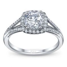 a white gold engagement ring with an oval cut diamond surrounded by pave set diamonds