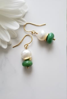 These are very adorable and easy to match any designs wire wrapped genuine Chrysoprase Plain Smooth Roundelle Dangle Earrings (stone size is 11-12 mm) in combination with White Freshwater Pearl beads (stone size is 10-11 mm) with Gold Vermeil wavy disk spacer beads. All metal components are solid 925 Sterling Silver plated with 24K gold (Vermeil). These earrings are 2.5 centimeters long. Chrysoprase Smooth Roundelle: 11-12 mm, Africa, Grade AA White Freshwater Pearl beads: 10-11 mm, Peru, Grade AA Designed and Made by AnGjewelry! They will be delivered in a cute gift box! ♡ The Chrysoprase stone is one of the best antidepressants in the world of crystal healing. Cooling and calming this gemstone was a favorite of Alexander the Great. Round Chrysoprase Earrings Gift, Elegant Nickel-free Chrysoprase Jewelry, Jade Earrings With Ear Wire For May Birthstone, Handmade Elegant Chrysoprase Earrings, Elegant Handmade Chrysoprase Earrings, Elegant Wire Wrapped Earrings For May Birthstone, Green Dangle Pearl Earrings With Ear Wire, Jade Wire Wrapped Drop Earrings, Green Onyx Dangle Earrings Gift