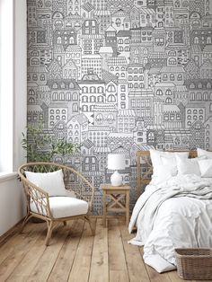 a bed room with a neatly made bed next to a chair and wallpaper on the walls