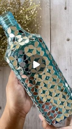 a person holding a bottle with holes in it