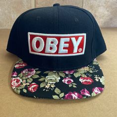 Never Worn, Snapback Hat From Obey Stitched Block Logo With Red And White And Floral Patterned Brim Adjustable Brimmed Snapback Hat For Streetwear, Casual Brimmed Snapback Hat For Streetwear, Casual Adjustable Brimmed Snapback Hat, Casual Snapback Hat For Streetwear, Casual Streetwear Snapback Hat, Casual Black Brimmed Snapback Hat, Spring Black Adjustable Snapback Hat, Black Adjustable Snapback Hat For Spring, Casual Brimmed Snapback Hat