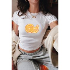 Embrace the vibrant nostalgia of Y2K with our Orange Slices Baby Tee, a flirty crop top reminiscent of coquette vintage fashion. Featuring a playful fruit print design, this girly-girl top is the perfect summer statement piece for women who adore retro charm.  🦢・️✩   ＊ Baby-style tee shirts ੈ༺☆༻*ੈ ᡣ𐭩PRODUCT DETAILS: - The heavy cotton tee is a KIDS SIZE SHIRT, so please size accordingly(using the chart provided).   ᡣ𐭩BABY TEE (YOUTH SIZE - Gildan Brand G5000B  - 100% ethically grown and harvested US cotton  - Midweight fabric (5.3 oz/yd² (180 g/m  *ੈ༺☆༻*ੈ  𐙚 SHIPPING:  - Processing time is 2-5 business days  *ੈ༺☆༻*ੈ ʚɞ SHOP POLICY:   - We do not accept returns and exchanges, but if you have received the wrong/damaged items or quality, send a message with photos, and we can find a solut White Fitted Cropped T-shirt Y2k Style, White Y2k Cropped T-shirt, Retro Fitted Crop Top T-shirt, Spring Y2k Crew Neck Crop Top, Spring Y2k Style Crew Neck Crop Top, Spring Y2k Crop Top With Crew Neck, Spring Y2k Style Crop Top With Crew Neck, Yellow Y2k Crop Top For Spring, 90s Style Crop Top T-shirt For Summer