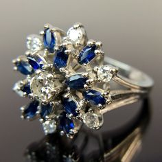 Metal:14k White Gold Weight:6.2 Grams Size:6.25 CTW:1.2 - 1.49 Carats 1 3.5mm round diamond 6 2.25mm round diamonds 12 3.5mm by 2mm marquise-cut sapphires, approx. 0.88 - 1.08 carats Make an offer! Dazzling Multi-stone Platinum Diamond Ring, Multi-stone Round Sapphire Ring In Platinum, Platinum Cluster Multi-stone Diamond Ring, Platinum Multi-stone Cluster Diamond Ring, White Gold Marquise Multi-stone Diamond Ring, Diamond White Multi-stone Ring For Formal Occasions, Diamond White Marquise Multi-stone Ring, Diamond White Multi-stone Marquise Rings, Diamond White Multi-stone Oval Diamond Ring