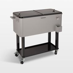 the cooler is sitting on wheels and has two compartments for it to hold drinks or other things