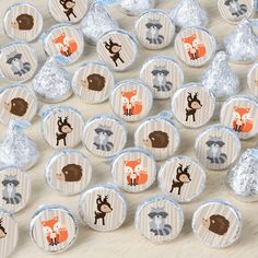 chocolate candies with woodland animals on them are sitting on a table next to foil wrappers