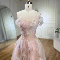 a dress is displayed on a mannequin in a room