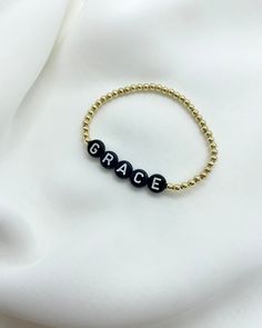 Choose a name, place, team, word or initial. Make it your own and wear your heart on your wrist! 3mm Gold Filled or Sterling Silver beads used with white letters on black beads. Choose your size for a custom bracelet made just for you! Circle letter bracelets look best with a short phrase or name. If you have a longer name or phrase you would like, please check out our “Dainty Name Bracelet” that use smaller square beads that accommodate longer names/phrases better. If you would like initials/sh Team Word, Letter Bracelets, Square Beads, Custom Bracelet, Letter Bracelet, Gold Alloys, Square Bead, Name Bracelet, White Letters