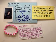 a bulletin board with notes, pictures and a pink bracelet on it's side