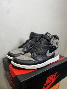 Elevate your sneaker collection with these classic Jordan 1 Retro High OG Shadow 2018 kicks. The black leather upper, along with the high top shoe shaft style, exudes a sleek, retro vibe that's perfect for any casual occasion. These athletic sneakers come in size 10 and feature the iconic Air Jordan 1 model, making them a must-have for any sneakerhead looking to add to their collection. The shoe's details, such as the Style Code 555088-013 and the Retro theme, add to its unique appeal. Whether you're hitting the gym or just running errands, these Air Jordan 1s provide both comfort and style. Used With box and 2 lace colors (black and grey) Mens Jordans Size 10, Jordan 1 Shoe Collection, Air Jordan 1s, High Top Shoe, Jordan 1s, Retro Theme, Jordan 1 Retro High, Jordan 1 Retro, Model Making