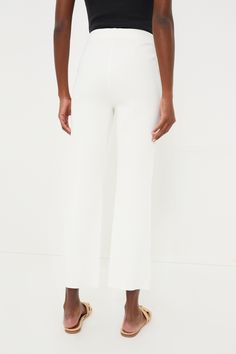 A Tuckernuck staple, the Ivory Ashford Pants are your new wear anytime, anywhere bottom. Crafted from a stretch knit fabric that holds you in with the perfect touch of compression, this closet staple features a high rise and cropped kick flare hem that is equally flattering and effortless. We are pairing these throw-on-and-go bottoms with everything from blouses to sweaters to blazers. High rise Elastic waistband Pull on styling, no zipper Cropped kick flare hem Compression knit fabric Material: White Stretch Ankle-length Dress Pants, White Stretch Bottoms With Straight Hem, White Elastane Pants With 4-way Stretch, Off White Straight Leg Work Bottoms, White Straight Leg Dress Pants For Business Casual, Modern White Stretch Bottoms, Cream Stretch Straight Leg Pants, Cream Straight Hem Bottoms For Work, Spring White Wide Leg Elastane Pants