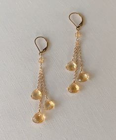 Citrine Long Dangle Earrings, November Birthstone Earrings, Yellow Citrine Jewelry Gorgeous citrine faceted teardrops sparkle as they dangle from gold filled chain. The lovely high-quality stones are approximately 7mm in size and a sparkle beautifully in the light! A perfect November birthstone earring. Approximate length is 2 1/2 - 2 3/4 inches. Also available in sterling silver and rose gold filled. *Please note that these are natural stones and may contain inclusions and slight variations in Gold Gemstone Drop Chandelier Earrings, Gold Long Drop Chandelier Earrings With Gemstones, Faceted Citrine Dangle Jewelry, Faceted Teardrop Citrine Jewelry, Teardrop Faceted Citrine Jewelry, Gold Teardrop Chandelier Earrings With Gemstones, Elegant Faceted Teardrop Dangle Earrings, Elegant Teardrop Citrine Jewelry, Elegant Faceted Dangle Teardrop Earrings