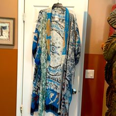 100% Polyester Beautiful Flowy Kimono Cape. Bohemian Printed Blue Kimono, One Size Blue Floral Print Kimono, Casual Blue Kimono For Festival, Blue One Size Kimono For Vacation, Blue One-size Kimono For Vacation, Blue Printed One Size Kimono, One Size Blue Printed Kimono, Blue One-size Kimono For Spring, Blue Printed One-size Kimono