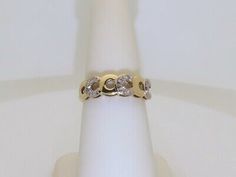 a gold ring with three diamonds on it