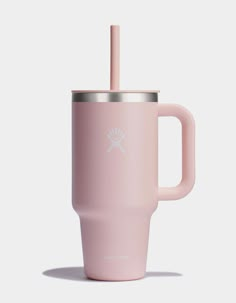 a pink tumbler cup with a straw in the middle and a logo on it