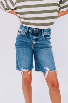 Get ready for a summer to remember with these playful high rise denim shorts. The rips and fraying at the bottom add a touch of edge and uniqueness, making these shorts a staple for any summer wardrobe. (Plus, they'll keep you looking cool while staying cool!) Details High rise fit Denim Rips/fraying at the bottom Sizing Approximate measurements: SIZE LENGTH/INSEAM WAIST Small 18/11" 30" Medium 19/11" 32" Large 19/11" 34" Fabric has stretchModel is 5’8 wearing small Material 97% Cotton 2% Elaste Summer Ripped Cutoff Jean Shorts, Ripped Medium Wash Cotton Shorts, Medium Wash Knee-length Jean Shorts For Spring, Trendy Frayed Hem Knee-length Jean Shorts, Trendy Shorts With Frayed Hem, Trendy Frayed Hem Knee-length Shorts, Trendy Knee-length Shorts With Frayed Hem, Summer Cotton Ripped Jean Shorts, Ripped Cotton Jean Shorts For Summer