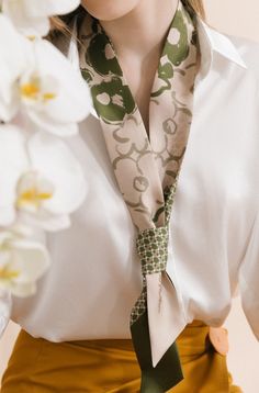 The floral graffiti design on one side of this silk skinny scarf adds a touch of fun and whimsy. The other side features a houndstooth pattern, adding another layer of sophistication to the piece. This scarf is versatile enough to be worn in many ways: as a necktie or headband, or just wrapped around your neck. It's the perfect accessory for any occasion and will make you stand out from the crowd! Product Description: 100% silk twill 120cm x 5cm ( 2"W x 47"L ) Double-sided stitching Two colors: Elegant Green Scarves For Spring, Trendy Silk Scarf For Spring, Trendy Green Silk Scarf For Spring, Trendy Spring Neckwear For Gifts, Elegant Spring Workwear Scarves, Trendy Scarves For Spring Workwear, Elegant Spring Scarves For Workwear, Trendy Spring Scarves For Workwear, Chic Green Silk Scarf For Spring