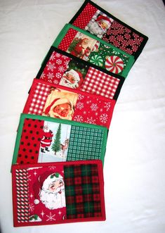 several christmas themed placemats laid out on a bed