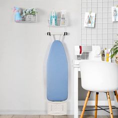 an ironing board on the wall next to a desk