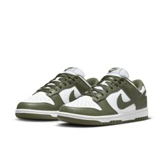 The Nike Women's Dunk Low 'Medium Olive' is the perfect blend of archival hoops style and contemporary design. Showcasing a classic two-tone color scheme, these comfortable sneakers feature a crisp white base with olive green overlays for added depth. The Nike Swoosh further accents the design in color-matched detail. Underpinned by a traditional rubber cupsole, the cushioning foam wedge provides superior comfort and impact protection, while the olive outsole ensures reliable traction when on the court. This updated version of the iconic Be True to Your School series from 1985 delivers timeless appeal with modern performance tech that make sure you stand out in style and comfort. Nike Dunk Low Medium Olive, Dunk Lows, Kitty Pictures, Sneaker Trend, Nike Model, Nike Models, Veja Sneakers, Adidas Spezial, Baskets Nike