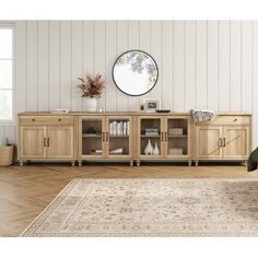 a living room scene with focus on the sideboard and large round mirror above it