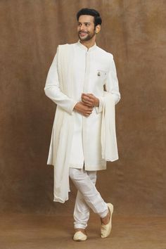 White sherwani with placed floral and sequin embroidery.
Components: 1
Pattern: Embroidered
Type Of Work: Thread,Sequin
Neckline: Mandarin Collar
Sleeve Type: Full
Fabric: Silk
Color: White
Other Details: 
Straight silhouette
Closure: Front closure
Note:
The fabric is silk blend and not pure silk
Churidar, brooch and dupatta worn by the model is not for sale
Occasion: Sangeet,Mehendi and Puja - Aza Fashions Traditional Chikankari Embroidered Sherwani In Raw Silk, Festive Off White Sherwani With Resham Embroidery, Off White Sherwani With Resham Embroidery For Diwali, Festive Off White Straight Kurta Sherwani, Festive Off White Traditional Wear With Dabka, Off White Bandhgala With Chikankari Embroidery, Festive Off-white Traditional Wear With Dabka, Off White Traditional Wear With Dabka For Designer Occasions, Off White Sherwani With Chikankari Embroidery