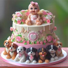 there is a cake decorated with puppies on the top and one baby in the middle