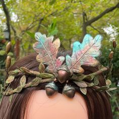 An enchanting handmade Woodland Crown, a statement headpiece designed to bring the beauty of the forest to life. This unique headpiece is the perfect addition to your costume for Renaissance faires, festivals, or simply to embrace the spirit of the woodland.The crown features a collection of handmade polymer clay oak leaves, hand-painted in the warm and earthy hues of Autumn. Among them, you'll find three charming acorns, symbolizing the season's bounty. Brown branches, flexible and adaptable, i Handmade Adjustable Headpiece For Masquerade, Adjustable Fantasy Headpiece For Fantasy Events, Fantasy Festival Crown Costume Accessories, Adjustable Fantasy Style Headpiece For Events, Whimsical Headband For Costume Party, Bohemian Adjustable Headband For Costume Party, Adjustable Bohemian Headband For Costume Party, Whimsical Crown-shaped Headband For Festivals, Whimsical Crown-shaped Festival Headband