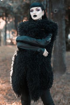 a woman dressed in black and white makeup