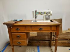 a sewing machine sitting on top of a wooden table