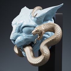 a blue and gold statue of a shark with a snake wrapped around it's mouth