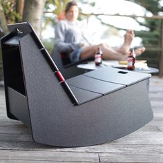 a man sitting at a table with two beer bottles and a laptop on it,